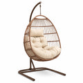 Sedia sospesa in rattan marrone con cuscino beige