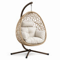 Poltrona sospesa in rattan sintetico con cuscini beige