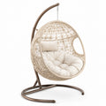 Sedia pensile in rattan con struttura in acciaio e cuscino beige